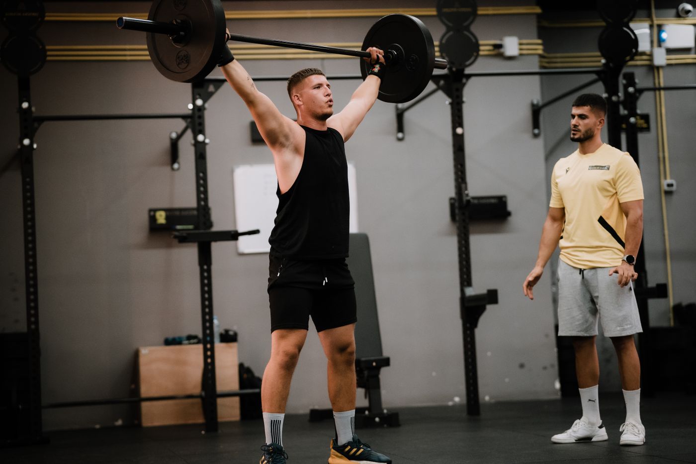 A coach watching a lift.