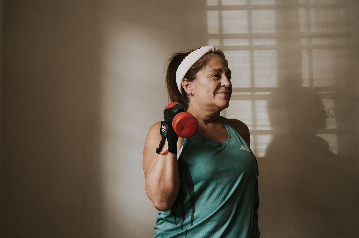 A still-training adult curling a dumbbell.